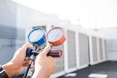 a technician adjusting the freon levels