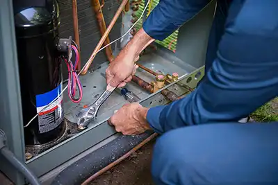 Our technician working on a central ac unit outside